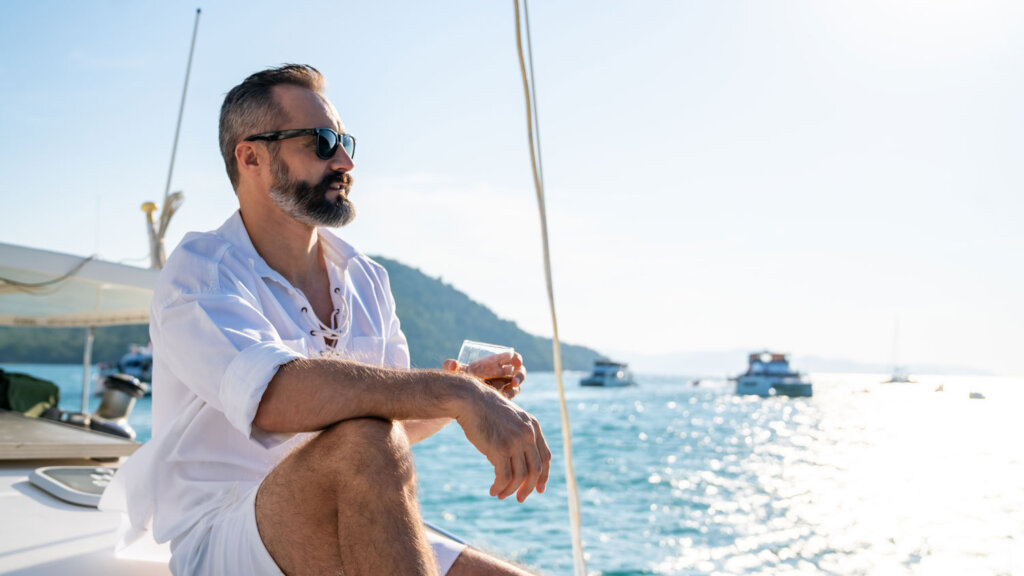 A travel advisor relaxing on a boat because AI tools saved him time drafting travel itineraries.